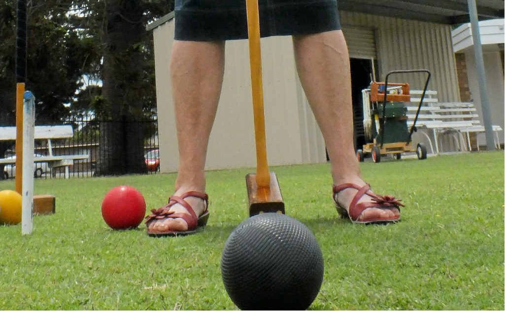 Despite a council decision not to remove a bunya tree (in background) adjoining the croquet grounds, Dorothy Gartery is worried about a potential risk to club members’ safety. Despite a council decision not to remove a bunya tree (in background) adjoining the croquet grounds, Dorothy Gartery is worried about a potential risk to club members’ safety.